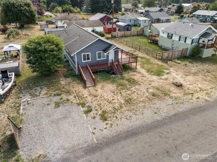 From above you can see just how much parking this property offers. A front gravel pad handles multiple vehicles or RVs with no problem, while the alley in back gives you a second way in. For anyone juggling cars, toys, or gear, this lot makes it easy.