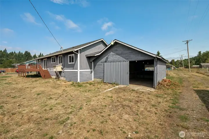 The garage comes with a sliding barn-style metal door that looks like it’s for one car, but at just over 23 feet long it can actually fit two in tandem. Access is from the alley, with a level yard that may be more “end of summer dormancy” than curb appeal. The siding on the garage could use some love, and that’s already been factored into the price.
