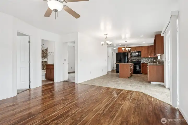 This shot captures the flow that makes the home livable. The front bedroom and full bath sit just off the living room for easy access, while the hallway draws you toward additional bedrooms tucked beyond the dining and kitchen wall. It’s a floor plan that works, giving separation without losing that open feel.