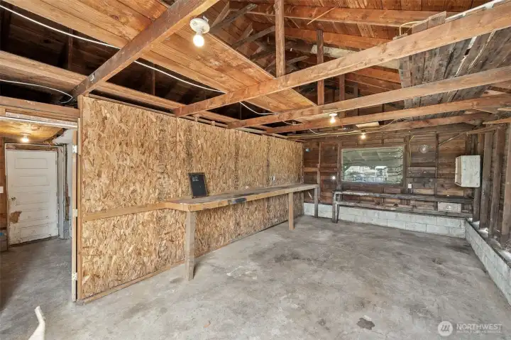 The garage is more than a parking spot, with a concrete floor for projects, open rafters that double as overhead storage, and a window out back that keeps it from feeling like a cave. The best part? A door that leads straight into the workshop, which basically makes this a command center for anyone with tools, toys, or hobbies that need room to spread out.