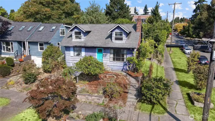 INVESTOR/BUILDER ALERT! Bring your vision & tool belt to unlock endless potential in this diamond in the rough jewel in highly coveted Sunset Hill. Cape Cod home on a prime 5,000 sq.ft corner lot NR3 zoned offers incredible opportunity to restore home and/or build multiple dwelling units. Main floor with 3 bedrooms, full bath, original hardwood flooring, wood-burning fireplace. Upstairs is 2 additional bedrooms and half bath. Unfinished basement offers additional potential living space or used as a workshop. 1-car attached garage. Newer 2024 water heater. Fully-fenced lot with great outdoor space in front and back with extended patio. Nestled on a quiet street, short stroll to local favorites Picolino’s & Baker’s. Catch mesmerizing Olympic Mt. & Puget Sound views at Shilshole Marina, Sunset Hill Park, minutes to Golden Gardens, Ballard Locks.