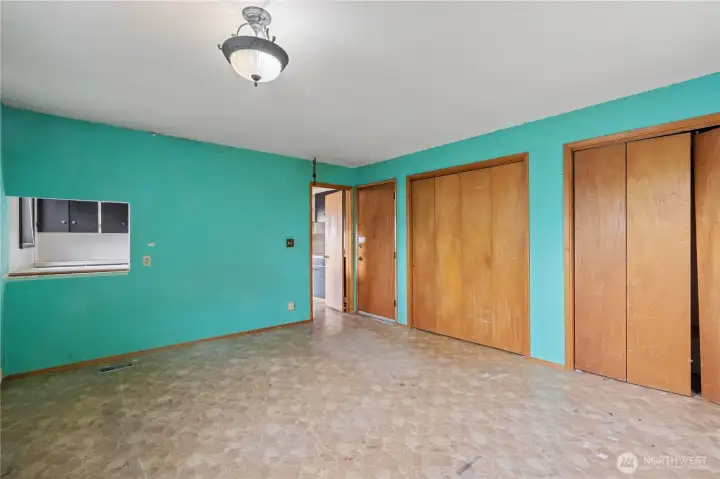 Primary bedroom with dual closets and a side door that leads to the backyard.