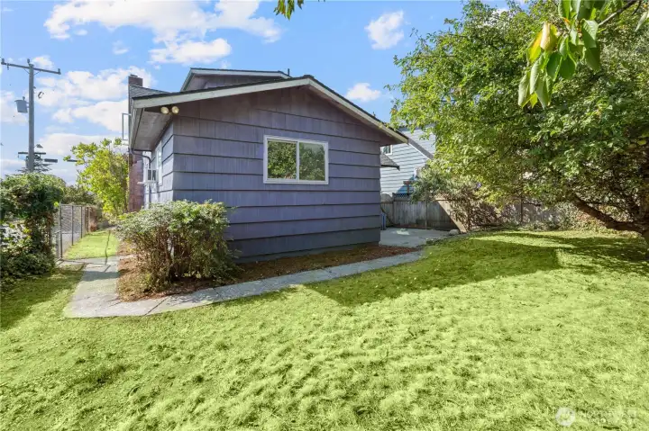 The spacious leveled backyard with mature trees for privacy.