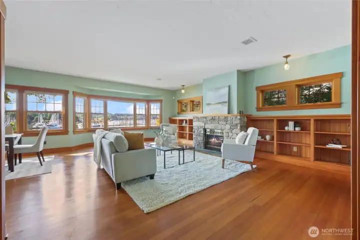 The reclaimed wood floors goes so well with the built-ins and trim. The gas fireplace keeps you cozy too.
