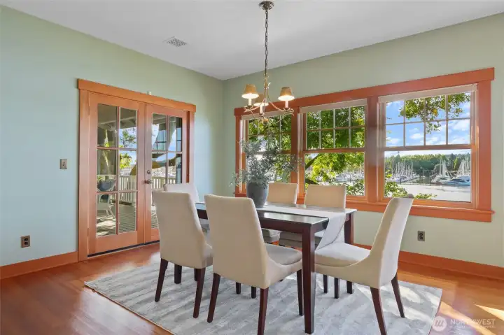 Light filled dining room with double doors (with hidden screens) out to the deck overlooking Swantown Marina.