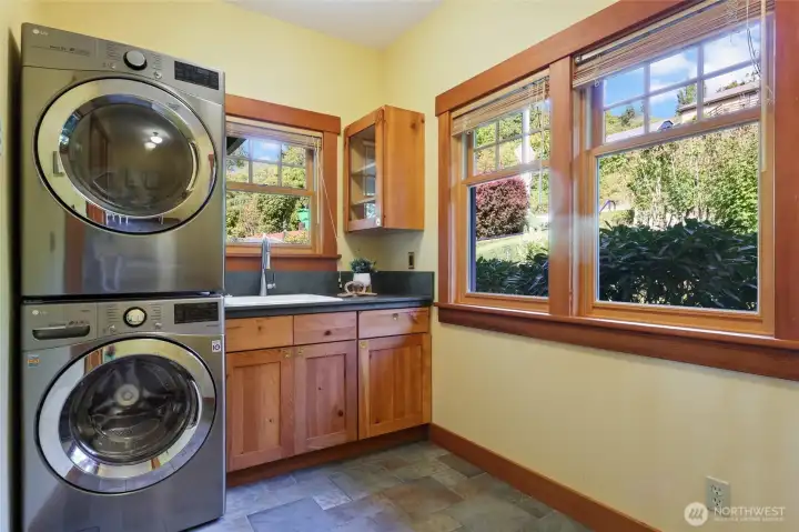 Large, bright laundry room with sink and stainless washer/dryer (included in sale). Plenty of room for table, shelving, ironing board, . . . Not pictured is a walk-in closet for even more storage.