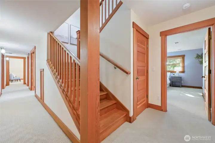 Beautiful wood stairway. Door opens to storage under stairs - notice the small door on the left which also leads to the back of the closet.