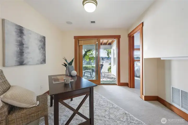 Den just off the primary bedroom and hall leading to the back patio and waterfront.