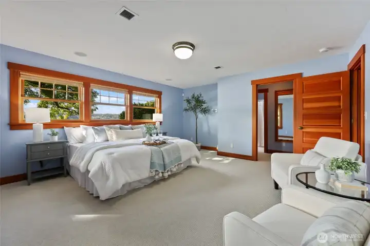 Another view of the primary bedroom. Door leads into the primary bathroom and walk-in closet.