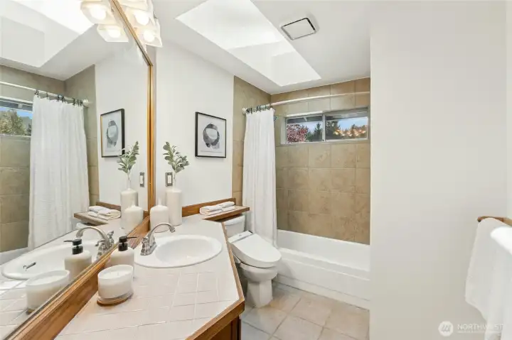 Upstairs full guest bath with installed bidet ensures comfort for all.