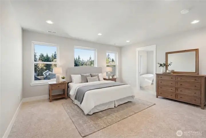 This home has 2 primary suites! One on each level. This is the upstairs Primary Suite - complete with a primary bathroom and walk-in closet. Large room, large windows for natural light!