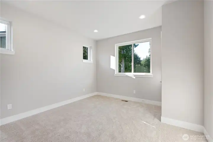 Downstairs Primary Suite features picture windows, two closets, and primary bathroom.