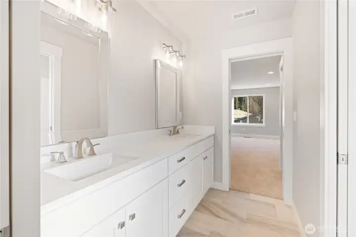 This Jack and Jill bathroom is share between bedrooms #3 and #4, long double sink vanity, with pocket doors on each bedroom for privacy, titled flooring, under cabinet lighting, and a separate toilet and shower room!