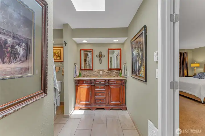 Primary bathroom with heated tile floors and skylight. Dual sink vanity. Primary bathroom with heated tile floors and skylight. Dual sink vanity.