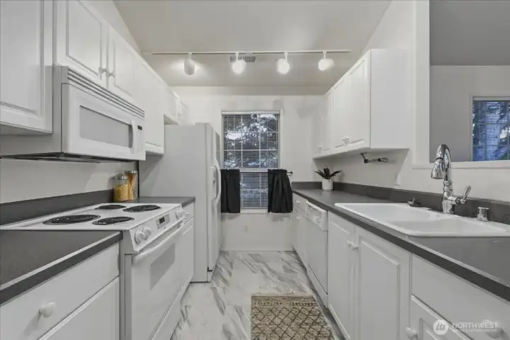 Kitchen, all appliances stay, track lighting, disposal, free-standing range, free-standing fridge