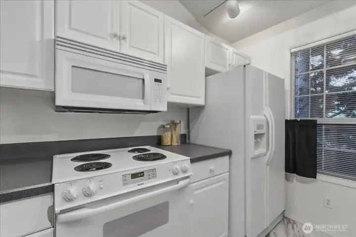 Kitchen, all appliances stay, track lighting, disposal, free-standing range, free-standing fridge