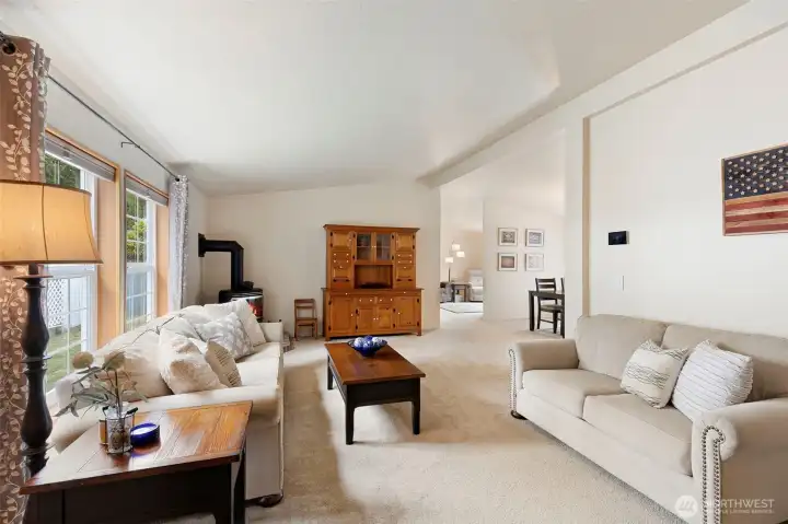 Entry leads to the living room area.  The seller has added a freestanding natural gas stove and also has a newer furnace and heat pump which not only provided efficient heat but also Air conditioning.