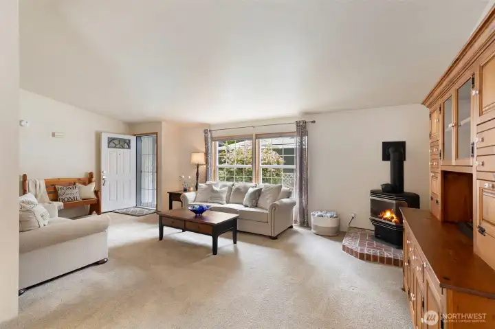 View taken from the Dining Area.  Gas freestanding stove is a corner set installation on a brick hearth.
