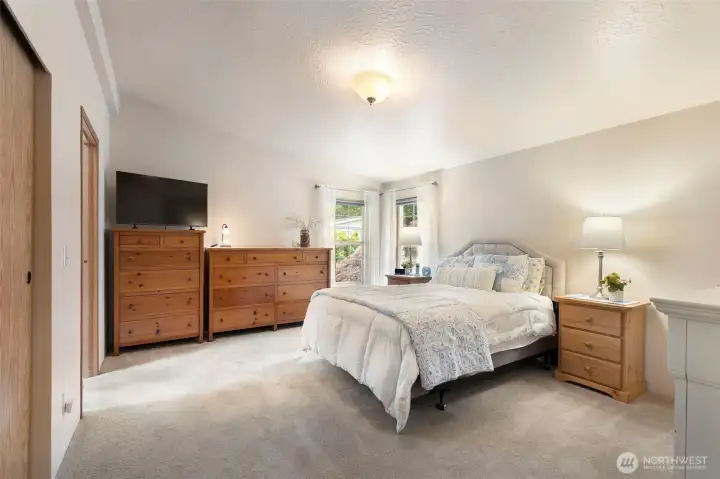 Primary Bedroom with plenty of closet space and two corner windows bring in the sunshine.