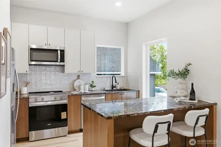 Well appointed open kitchen with marble countertops