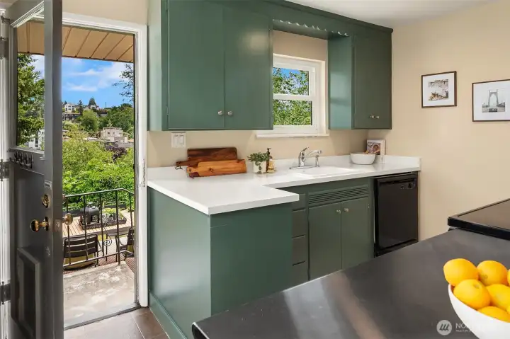 The kitchen has a back door that leads out to the back deck and yard as well as the back garage door.
