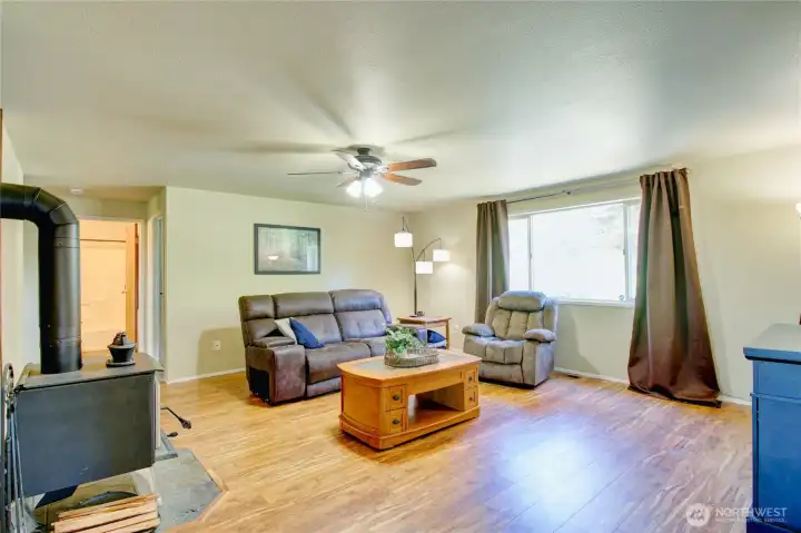 Large, open living room with wood burning stove. Large, open living room with wood burning stove.