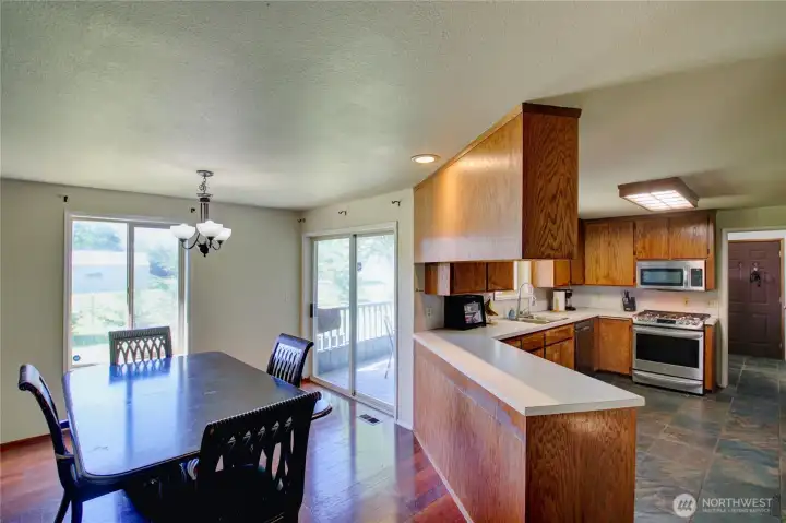 Dining area off kitchen with slider to back porch. Dining area off kitchen with slider to back porch.