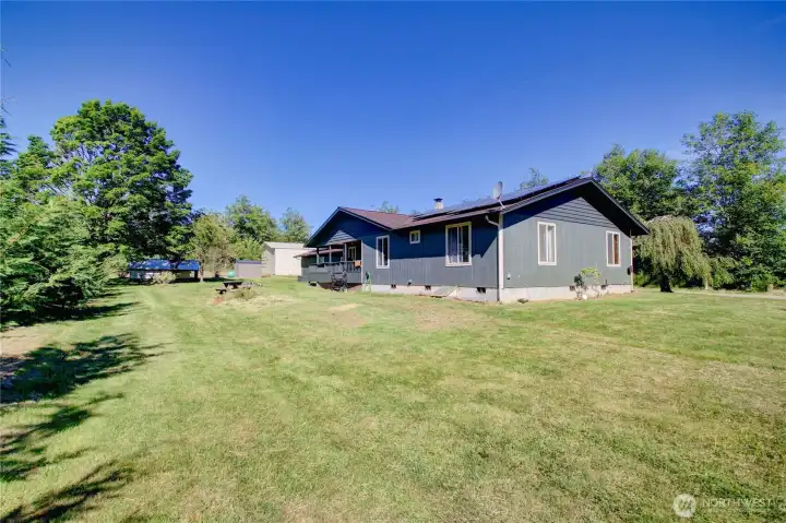 Large yard with firepit and picnic tables for outdoor entertaining. Large yard with firepit and picnic tables for outdoor entertaining.