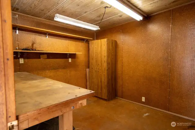 Shed off of carport with electrical complete with lights and work bench