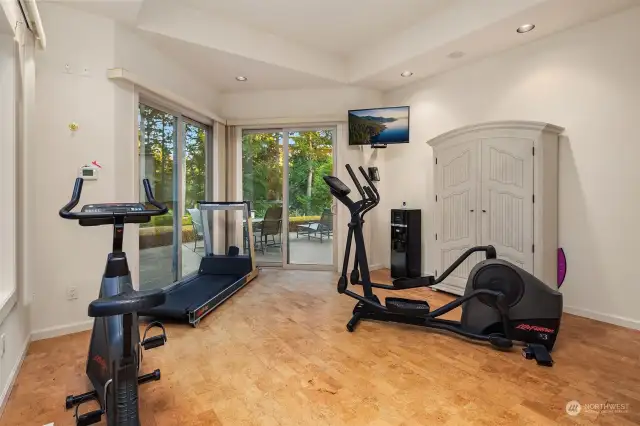 gym in the primary suite with views of the course & patio access