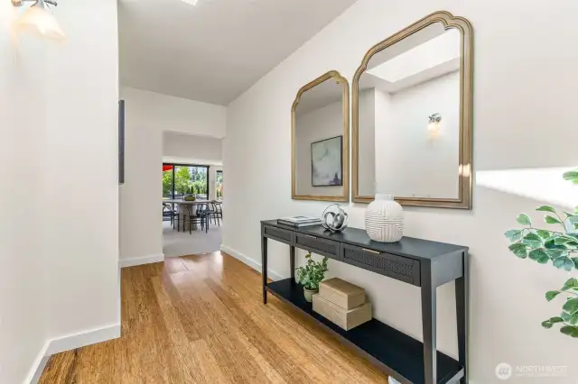 This lovely front entry hall is chaarming, spacious and looks terrific with the luxury vinyl plank floors!  There's a big skylight overhead to bring in natural light as well!