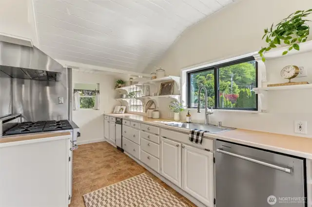 Charming and crisp tongue-and-groove ceiling adds cottage charm and character! So nice that this home enjoys a vaulted style of ceiling as well!
