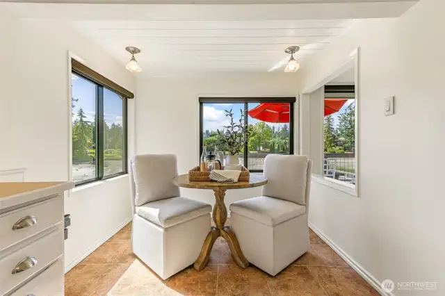 This charming breakfast nook affords a lovely view of the water and gardens.