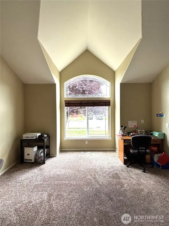 Living room off of dining room, with dramatic ceiling