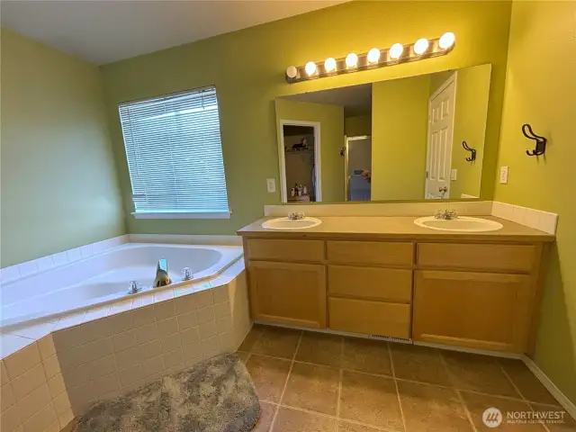 5-piece bathroom off of main bedroom with large soaking tub and double sinks.