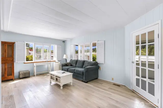 Portion of the living room with sunroom door on right