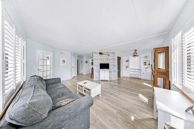 Living room showing dining area and hallway to bedrooms