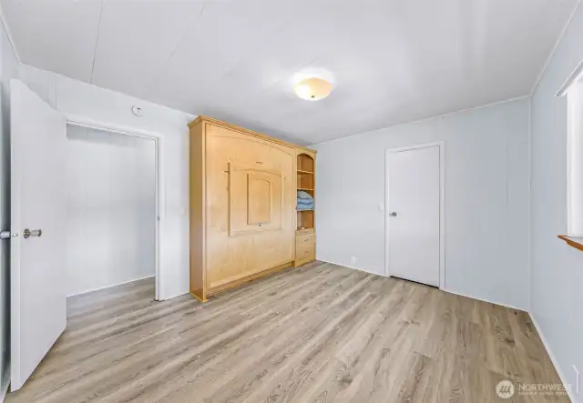2nd bedroom with custom built queen sign murphy bed that also has a table