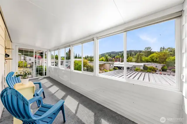 Sunroom facing SW with UV rolling shades and sliding glass door