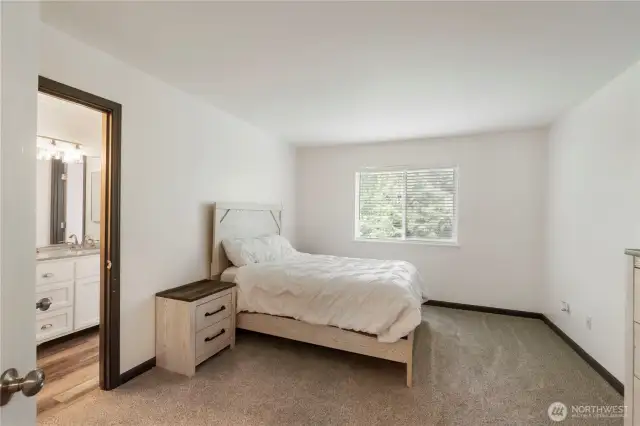 Primary Bedroom  Generously sized primary suite with room for a king-sized bed and private en-suite bath.