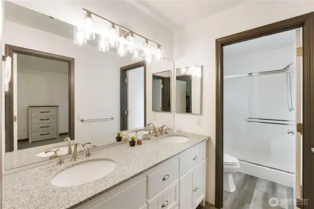 Primary Bathroom  Bright and functional en-suite with dual sinks, ample storage, and a walk-in shower.
