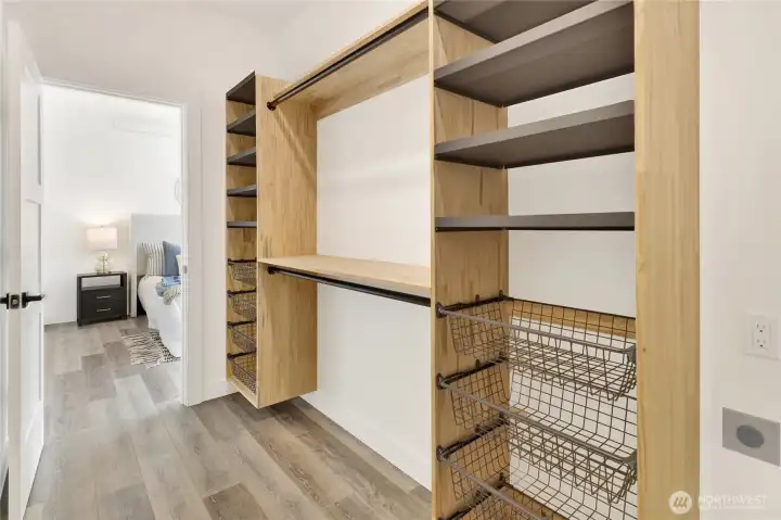 A second laundry area with washer/dryer hookups is located in the primary closet, while another laundry room is located on the main floor.