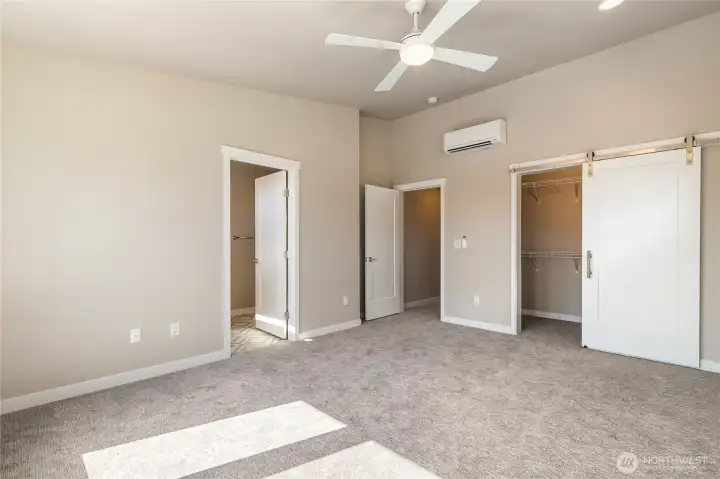 Tasteful barn door to right leads to walk-in closet. Door to right leads to ensuite