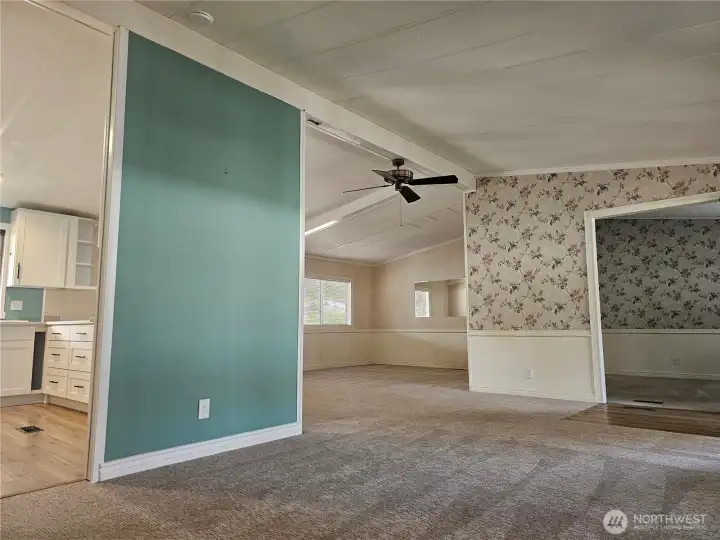 Open concept living with vaulted ceilings and fans