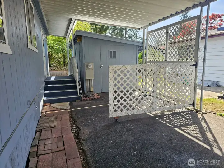Carport and convenient back entrance with storage/shop