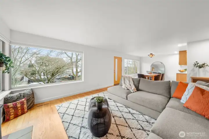 Expansive picture windows frame the elevated Bryant streetscape and bring in abundant natural light. Top-down bottom-up blinds are installed for privacy control while preserving views and architectural openness.