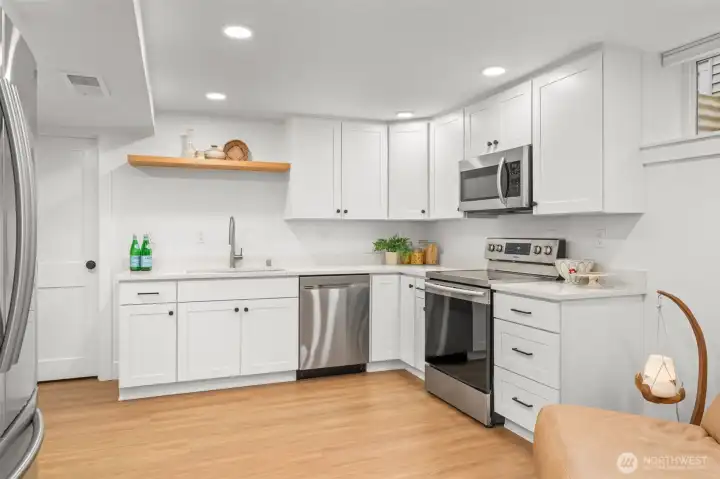 Fully equipped ADU kitchen with shaker cabinetry, quartz countertops, and stainless steel appliances designed for independent living.