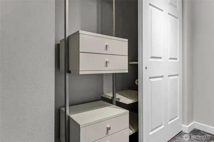 Custom closet system in primary bedroom  maximizes storage.