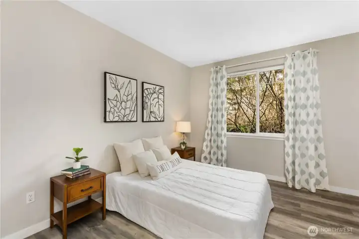 The spacious primary suite is thoughtfully located away from the secondary bedroom, offering added privacy and separation.