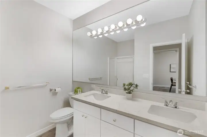 The ensuite bath offers convenience and functionality within the private primary retreat. Ample counter space allows for comfortable daily routines.